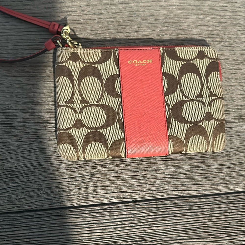 Small red and beige Coach wristlet.